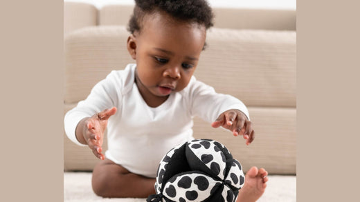 Baby plays with a sensory development toy