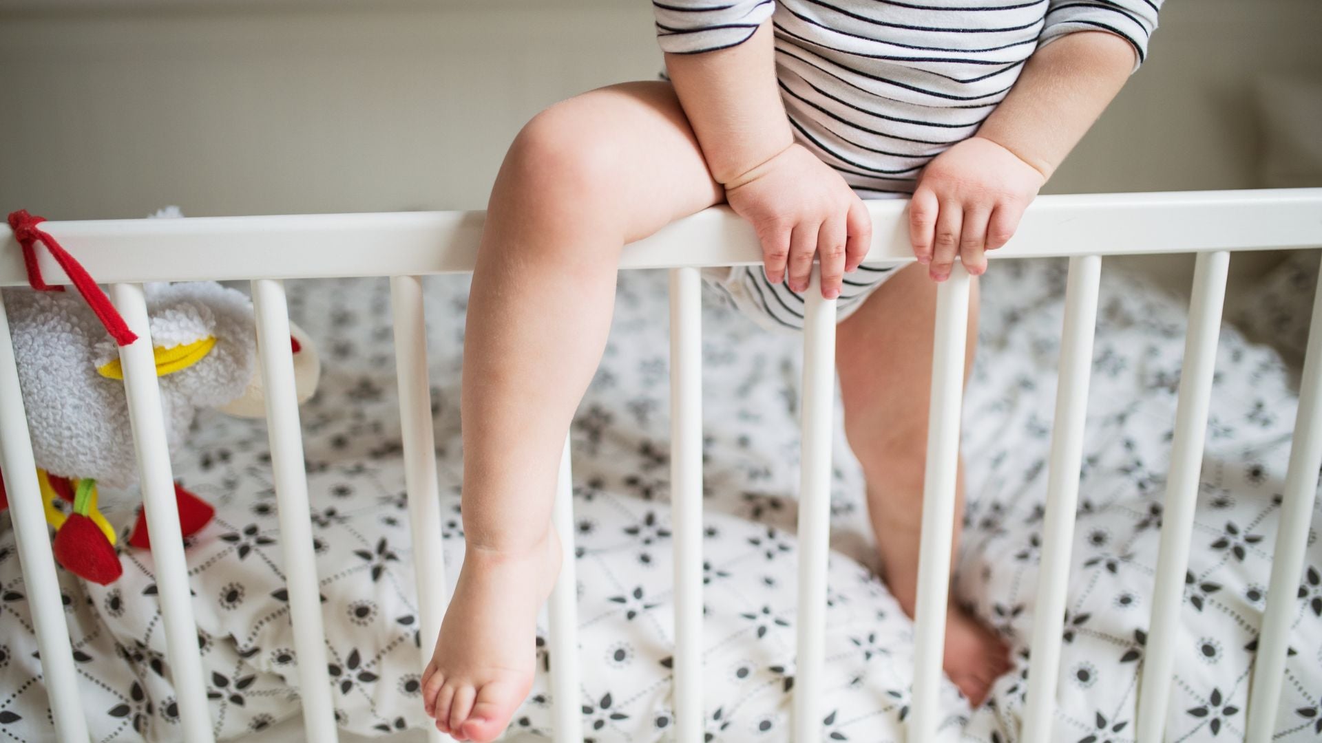 toddler climbing out of cot